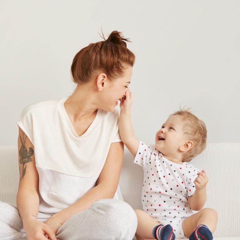 Fotolia Young mother with her one years old little son dressed in pajamas are relaxing and playing in the bedroom at the weekend together, lazy morning, warm and cozy scene. Selective focus.